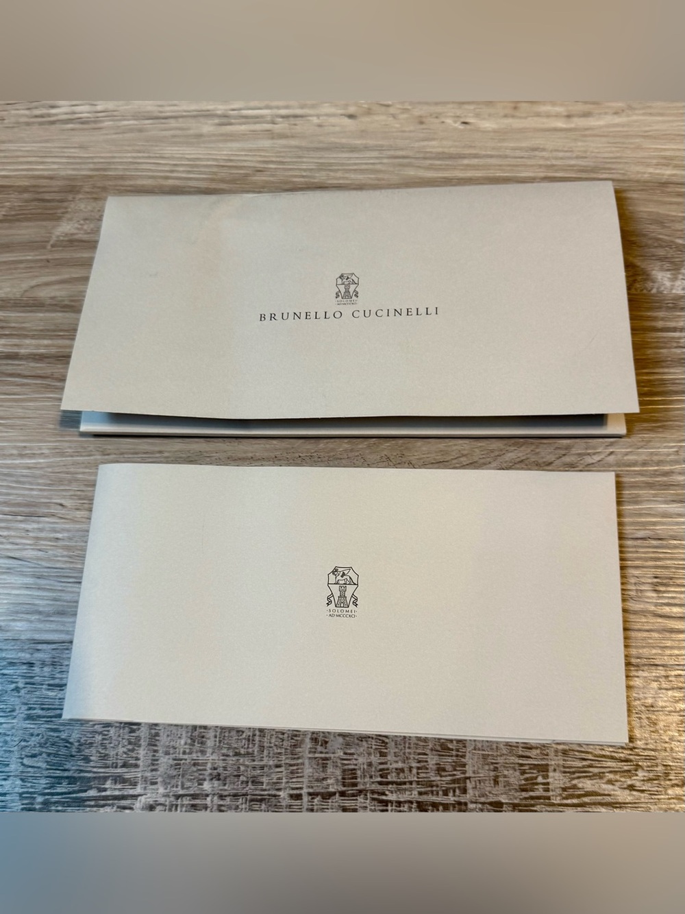 Brunello Cucinelli. This item consists of a branded envelope, a brochure, and a